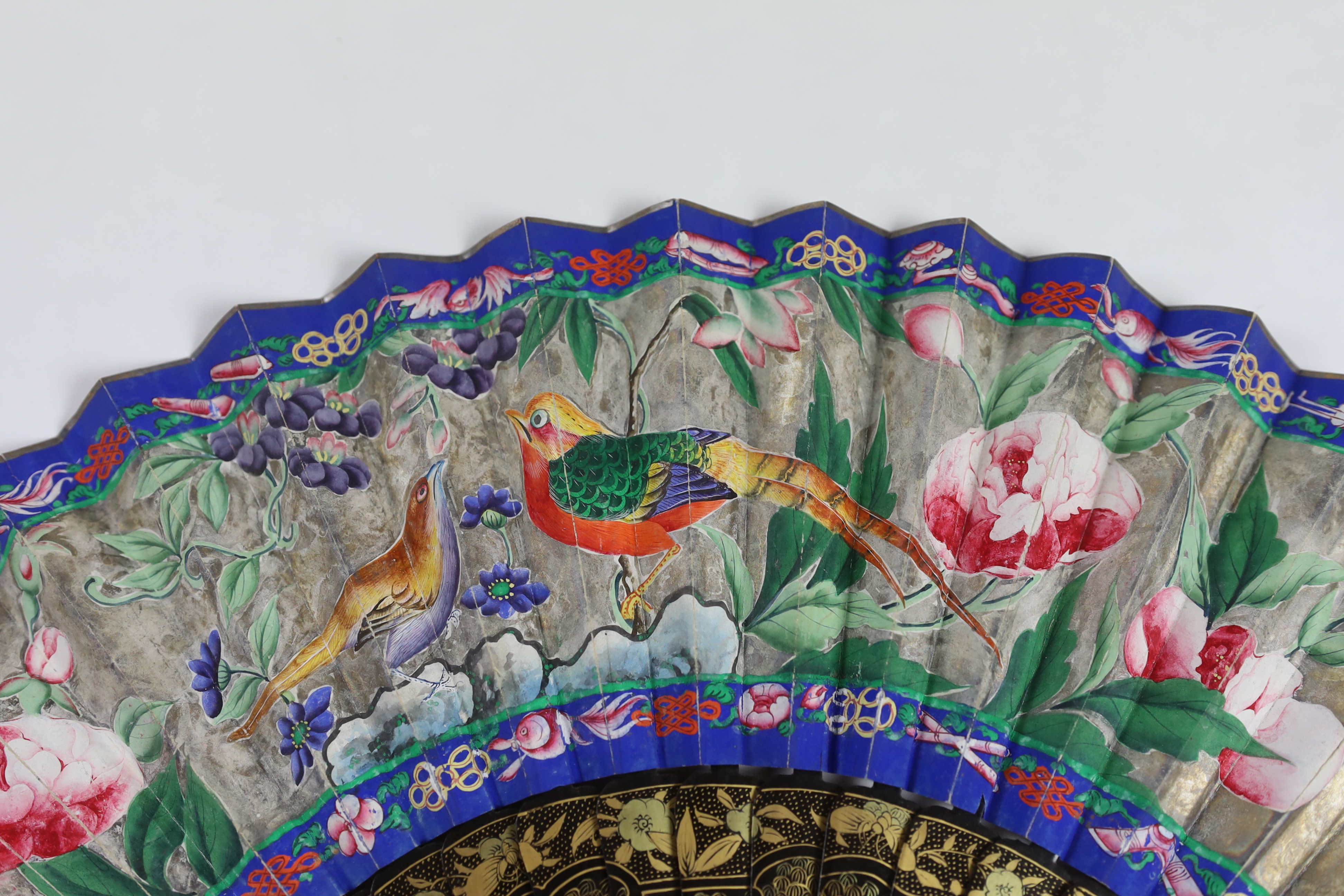 A 19th century Chinese ornately lacquered and hand painted figural leaf fan, the figures on the leaf having painted ivory faces, the back of the fan painted with exotic birds and flowers, CITES Submission reference TJUZX